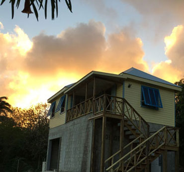 This is a temporary photo until the outside is clad in stone to replicate the West Indian skirt and blouse architectural style